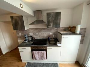 a kitchen with a sink and a stove top oven at Gemütliches Studio Rosenburgblick in Moselnähe in Zeltingen-Rachtig