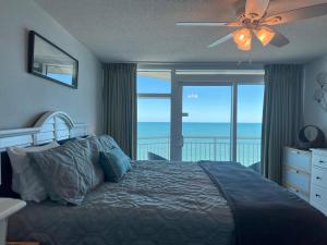 a bedroom with a bed with a view of the ocean at 2501 S Ocean Blvd, 1101 - Ocean Front Sleeps 8 in Myrtle Beach