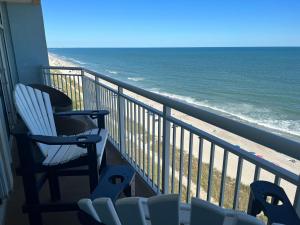 a balcony with two chairs and the ocean at 2501 S Ocean Blvd, 1101 - Ocean Front Sleeps 8 in Myrtle Beach
