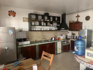 a kitchen with a refrigerator and a counter top at Hotel Pico Alto, La Planicie in Lima