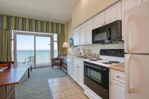 a kitchen with a view of the ocean at 2501 S Ocean Blvd, 1205 - Ocean Front Sleeps 6 in Myrtle Beach