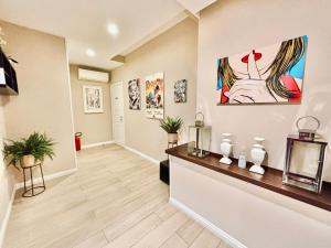 um corredor de uma casa com pinturas nas paredes em Les Suites Luxury Bari Certified Italian Excellence em Bari