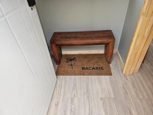 a wooden stool sitting on a floor in a hallway at Hotel Bacaris in Puerto Tranquilo