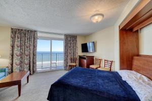 a bedroom with a bed and a view of the ocean at 1604 N Ocean Blvd, 0703 - Ocean Front Sleeps 6 in Myrtle Beach