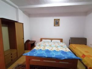 a bedroom with a bed with a blue comforter at Ohrid apartments in Ohrid