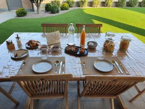 a wooden table with plates of food on it at B&B Casa Sara in Cassano dʼAdda