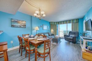 a dining room with a table and chairs and a living room at 2501 S Ocean Blvd, 0929 - Ocean View Sleeps 8 in Myrtle Beach