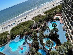 eine Luftansicht auf den Strand und die Pools in einem Resort in der Unterkunft 4800 S Ocean Blvd, 0915 - Ocean Front Sleeps 6 in Myrtle Beach