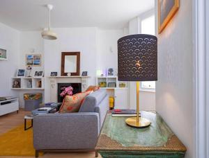 a living room with a couch and a table with a lamp at Shirlock Home - Italianflat in London