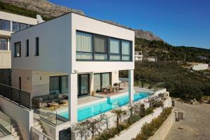 an aerial view of a house with a swimming pool at Villa Askana, 3 Bedrooms, 4 Baths, Infinity Pool, Whirlpool, Sea view, Outdoor kitchen in Jesenice