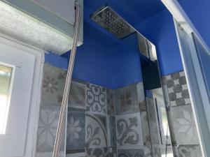 a bathroom with a shower with a blue ceiling at Casa Patrizia in Villapiana