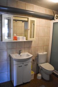 a bathroom with a sink and a toilet at White Hills Apartments in Budva