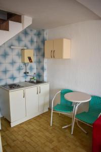 a kitchen with a table and two chairs and a table at White Hills Apartments in Budva