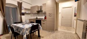 a kitchen with a table with a table cloth on it at Molfetta Central Station Studio in Molfetta