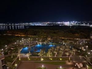a view of a park at night with lights at Comfort One Bed Room Apartment Gold Coast PIK in Jakarta