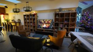 a living room with a christmas tree and a tv at Stara Plebania in Ponice