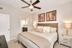 a bedroom with a bed and a ceiling fan at The Natural Mirage near Rice Village! in Houston