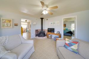 a living room with a couch and a fireplace at Cozy Bandera Cottage with Medina River Access! in Bandera