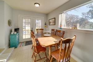 a dining room with a wooden table and chairs at Cozy Bandera Cottage with Medina River Access! in Bandera