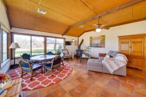 a living room with a table and a couch at Quiet Bandera Country Home with Medina River Access! in Bandera