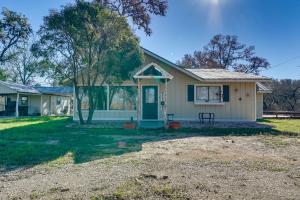 a house with a green door and a yard at Quiet Bandera Country Home with Medina River Access! in Bandera