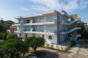 an apartment building with balconies on a hill at Sweet Home Luxury Apartments in Ialyssos