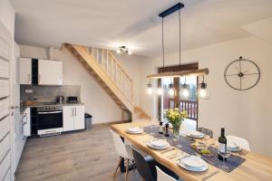 a kitchen and dining room with a table and chairs at Apartmány Louka in Vaclavov u Bruntalu