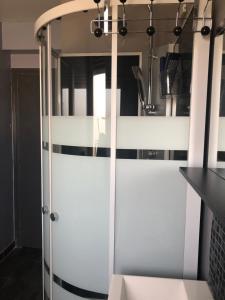 a kitchen with white sliding doors and a counter at Beauvais chambre 1 in Beauvais