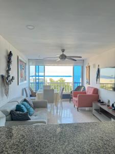 a living room with a couch and a dining room at Perla Santa - Luxury Condo in Santa Marta