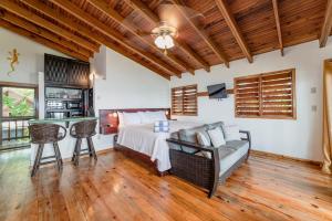 a bedroom with a bed and a desk in a room at Cocolobo Resort in West End