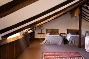 a bedroom with two beds in a attic at Mima's House · La Casa de Mima in Comillas