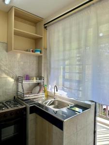 a kitchen with a sink and a window at Candy's Staycation in Thika