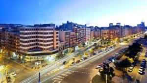 a city with a street with cars and buildings at Hotel Viladomat in Barcelona