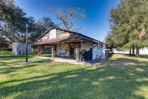 a small white house with a grass yard at Rustic Lake City Studio Near Ichetucknee Springs! in Lake City