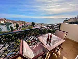 a balcony with a table and two chairs and the ocean at Apartamento con Vistas en Rincon de la Victoria in Cala del Moral