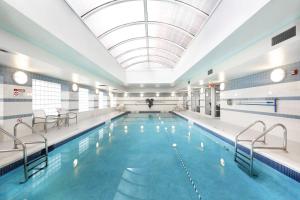 a large swimming pool with a large ceiling at Midtown East 3BR w Doorman Gym nr Bloomingdales NYC-915 in New York