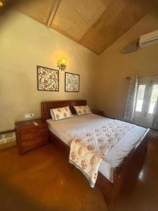 a bedroom with a large bed in a room at Book Rooms & Villa- Bairagarh Living Farm Stay in Shivpurī