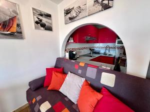 a living room with a couch and a kitchen at Apartamento con Vistas en Rincon de la Victoria in Cala del Moral