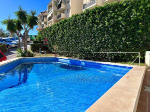 a large blue swimming pool next to a building at Apartamento con Vistas en Rincon de la Victoria in Cala del Moral