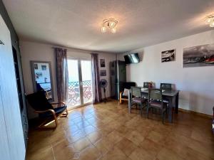 a living room with a dining room table and chairs at Apartamento con Vistas en Rincon de la Victoria in Cala del Moral