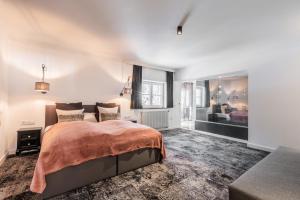 a bedroom with a large bed and a window at Love the Alps Apartments in Reith bei Seefeld