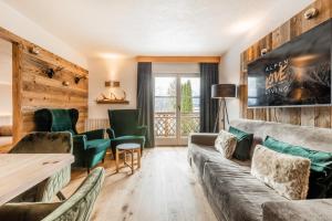 a living room with a couch and chairs at Love the Alps Apartments in Reith bei Seefeld