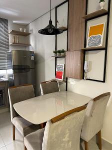 a kitchen with a dining room table and chairs at LOFTS CARIJOS CENTRO BH in Belo Horizonte