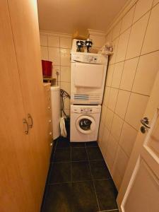 a small kitchen with a washing machine and a washer at Apartment in Sinnes Fjellstua 7 in Sinnes