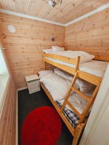 a bedroom with two bunk beds in a wooden room at Apartment in Sinnes Fjellstua 7 in Sinnes