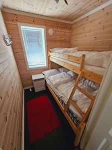 a bedroom with two bunk beds in a wooden cabin at Apartment in Sinnes Fjellstua 7 in Sinnes