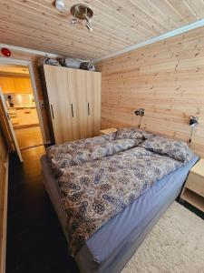 a bedroom with a bed in a wooden room at Apartment in Sinnes Fjellstua 7 in Sinnes