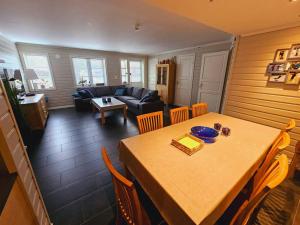 a living room with a table and a couch at Apartment in Sinnes Fjellstua 7 in Sinnes