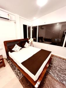 a bedroom with a large bed and a large window at Venitia Homestay in Alleppey