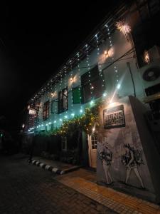 a building with a sign on the side of it at night at Bunk house Fort Kochi in Cochin